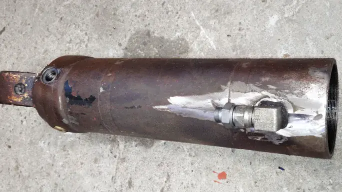 Hydraulic ram components showing precision engineering and repair work